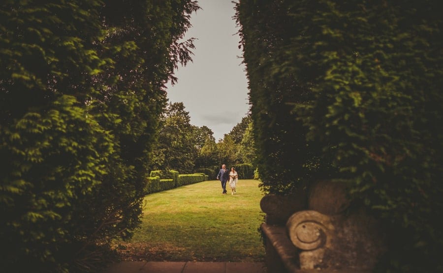 The bride and her father walking along the back lawn at Barley Wood house