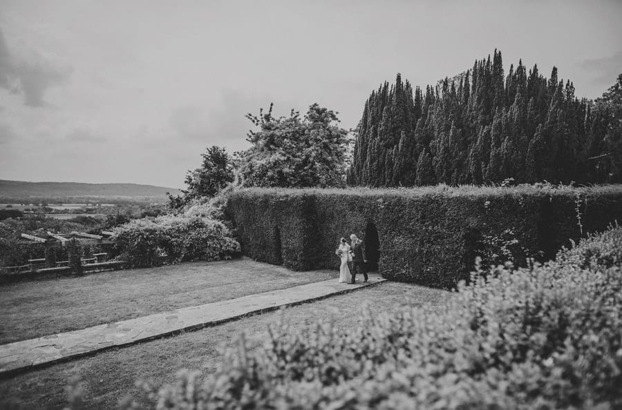 The bride and her father walking towards the outdoor ceremony at Barley Wood house