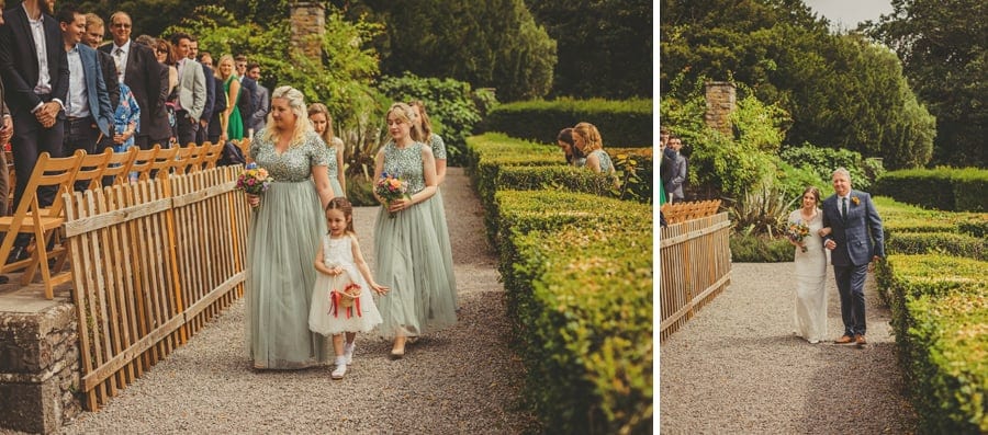 The bridesmaids, flower girl, the bride and her father arrive at the outdoor ceremony at Barley Wood house