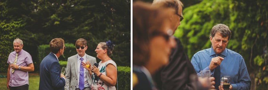 Wedding guests talking amongst themselves at the back of Barley Wood house