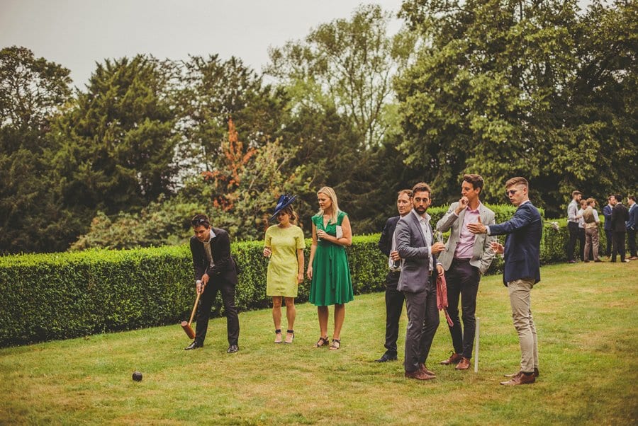 Wedding guests playing croquet on the lawn at Barley Wood house