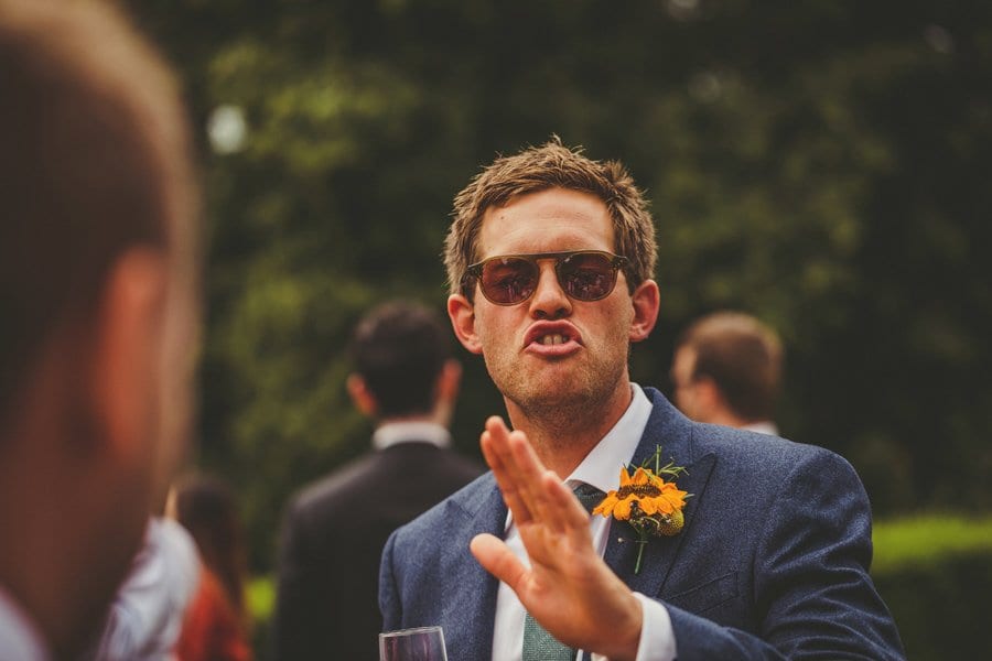 The best man talking to a wedding guest