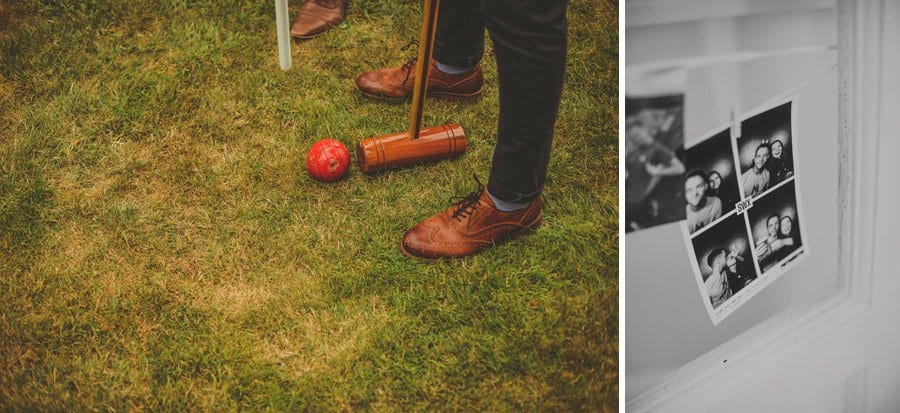 A man stands over a red croquet ball and attempts to hit it and a black and white photograph hangs from a ribbon