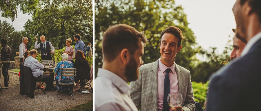 Wedding guests congregate at the back of Barley Wood house and talk amongst themselves