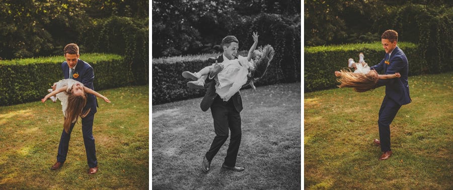 The groom swings the flower girl around in his arms