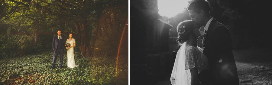 The bride and groom pose for photographs outside Barley Wood house as the sun sets in the background