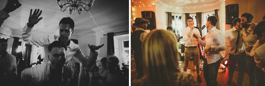 The groom on an ushers shoulders and wedding guests dancing