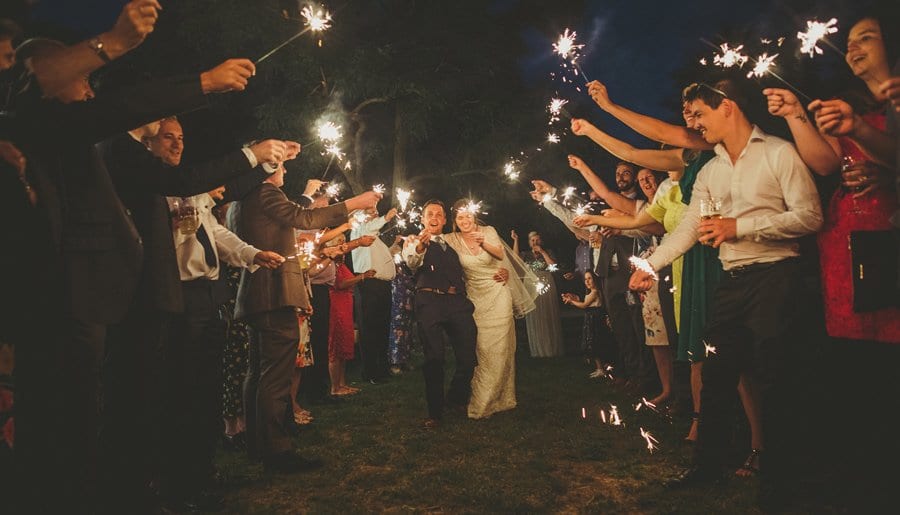 The wedding party holding sparklers up in the air