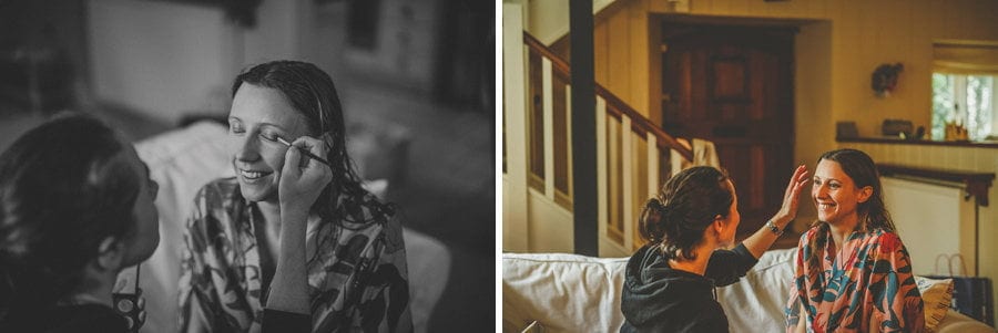 The make up artist applies makeup to the brides face