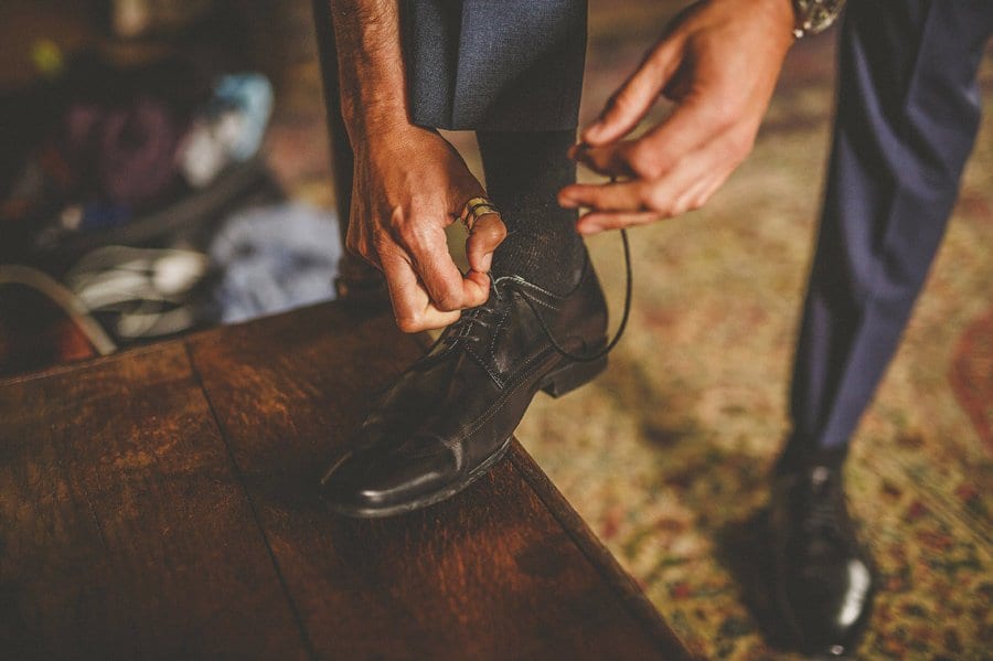 The groom ties his shoe laces