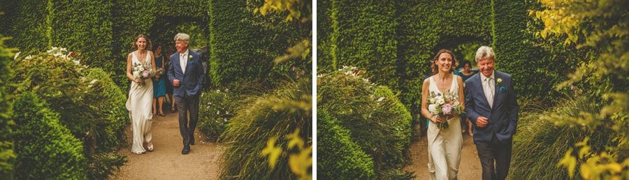 The bride and her father walk through the gardens at Abbey House