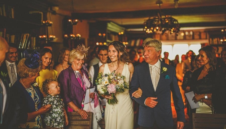 The bride and her father walk down the aisle at Abbey House Gardens