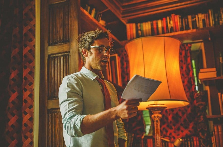 A wedding guest reads a poem during the wedding ceremony