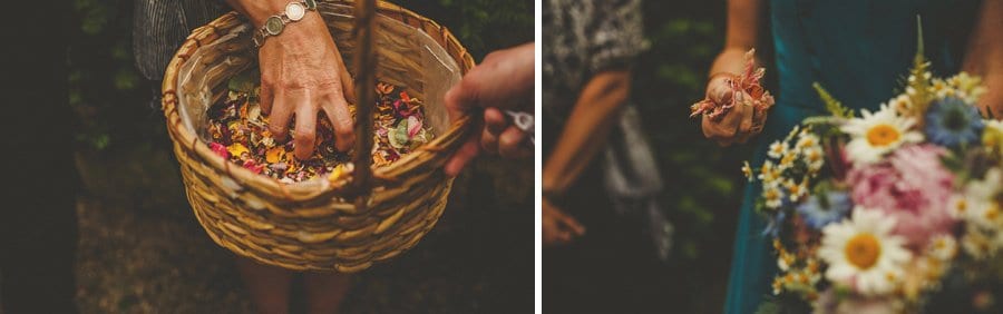 Wedding guests pick up confetti from a wicker basket outside the house