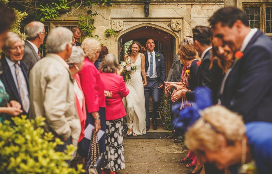 The bride and groom leave the house at Abbey House Gardens and are showered in confetti