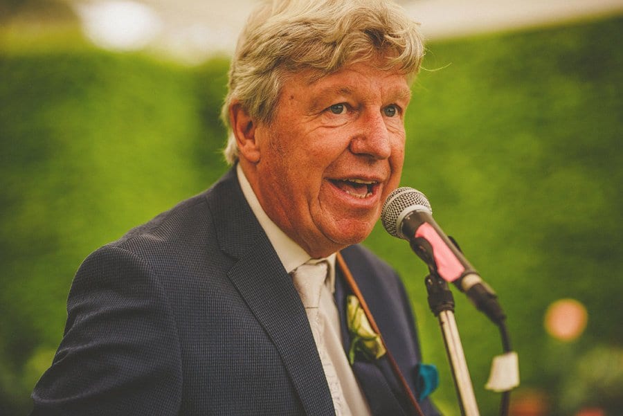 The bride's father plays guitar and sings a song