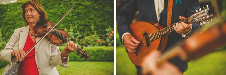 A lady plays violin and the brides father plays guitar