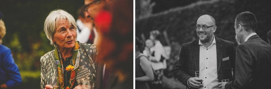 Wedding guests chat amongst each other in the gardens at Abbey House