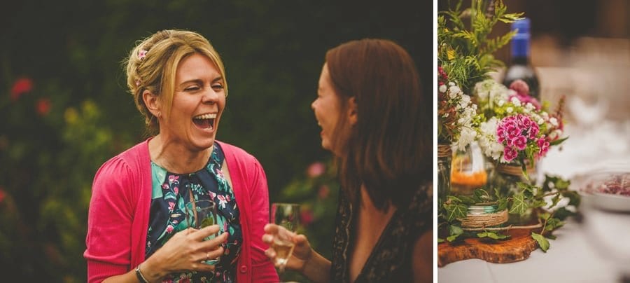 A lady laughs with her friend in the gardens at Abbey House