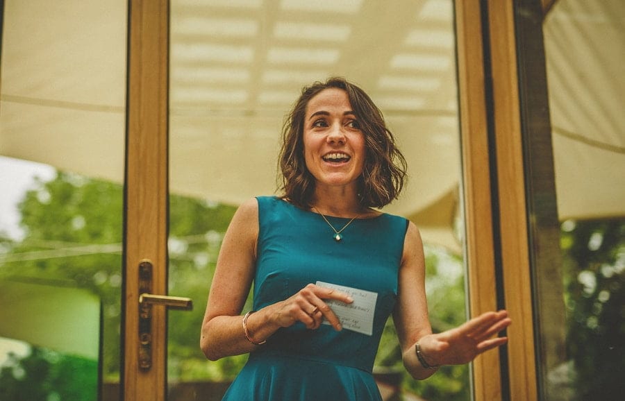 A bridesmaid stands up and delivers her speech to the wedding party