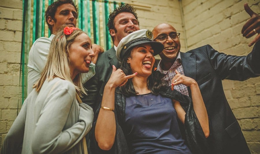 Wedding guests poses for a photograph in the photo booth