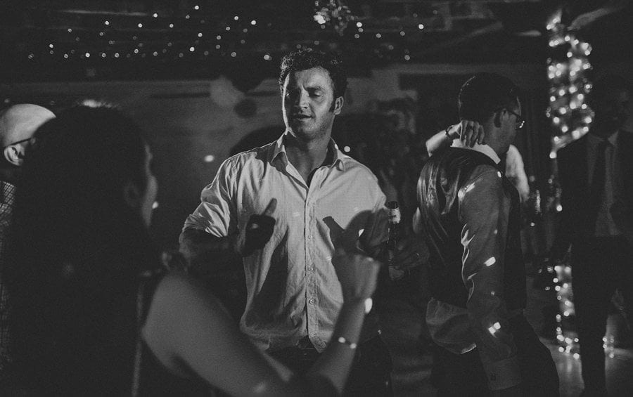 A wedding guest dancing with his wife