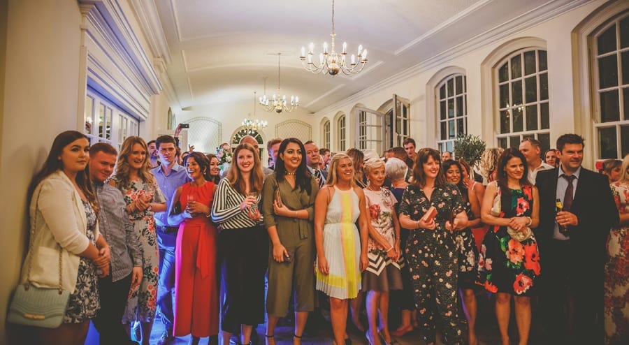 The wedding guests watch the bride and groom