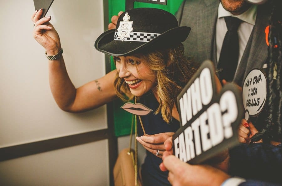 A wedding guest poses for a photograph in a photo booth in Clifton, Bristol