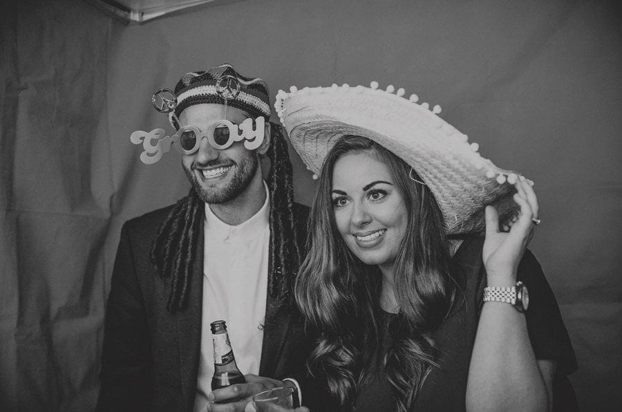 Wedding guests pose for photographs in the photo booth