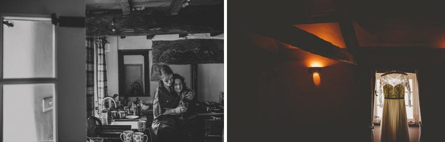 Two bridesmaids hug each other in the kitchen