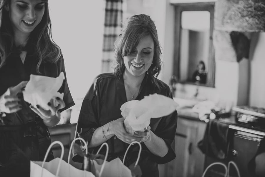 Bridesmaids open gifts given to them by the bride