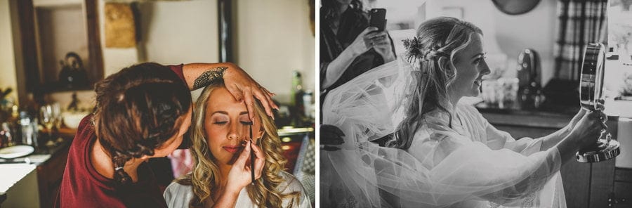 The makeup artist applies makeup to the brides face in the kitchen