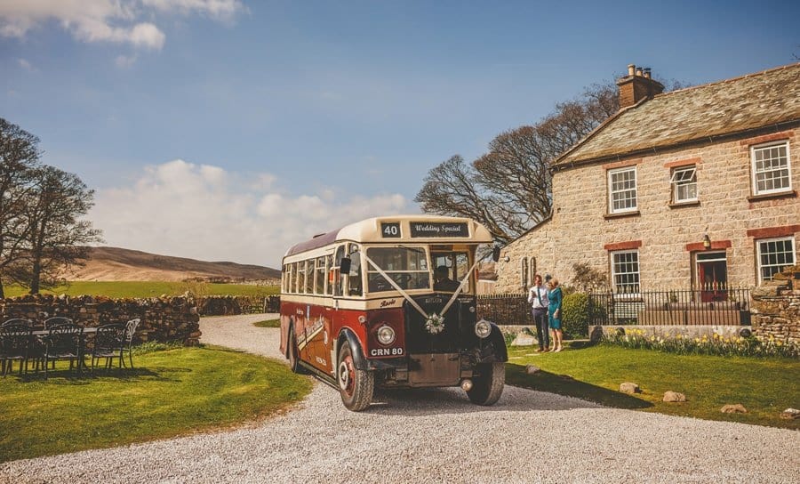 The wedding bus arrives outside the cottage