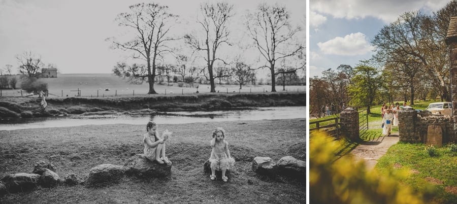 Two little girls sit on rocks in the garden of the Church