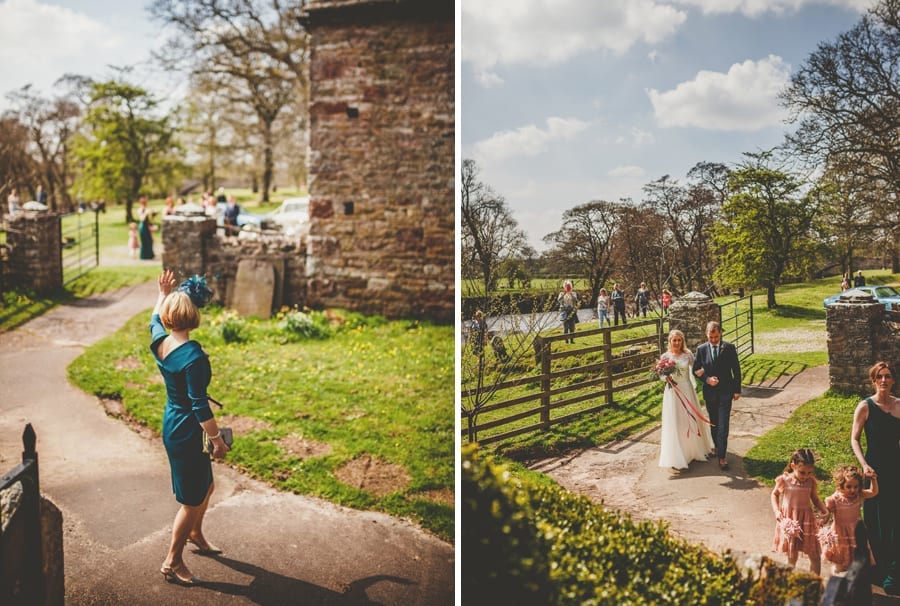 The mother of the bride waves at her husband and daughter and the bride and her father walk towards the Church