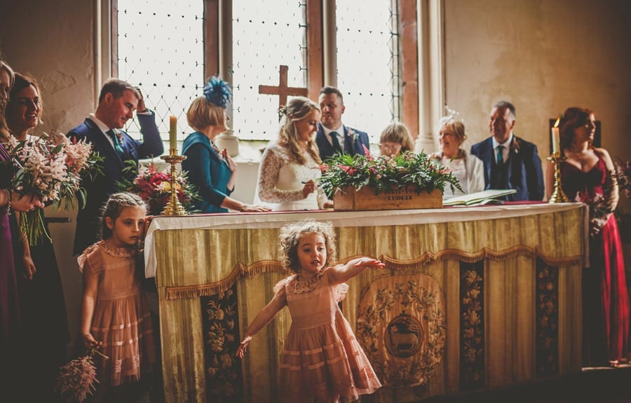 The wedding party sign the register in the Church