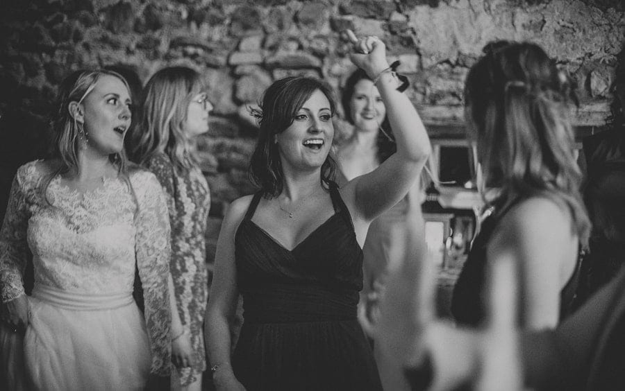 A bridesmaid dancing on the dancefloor in Eden Barn