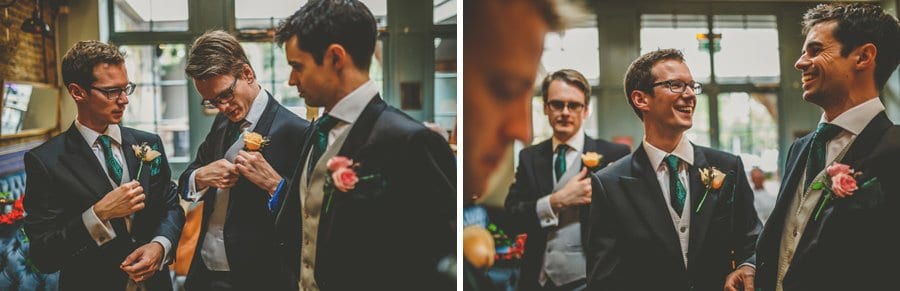 Ushers putting flowers on their suits in the Kings Arms in Fulham