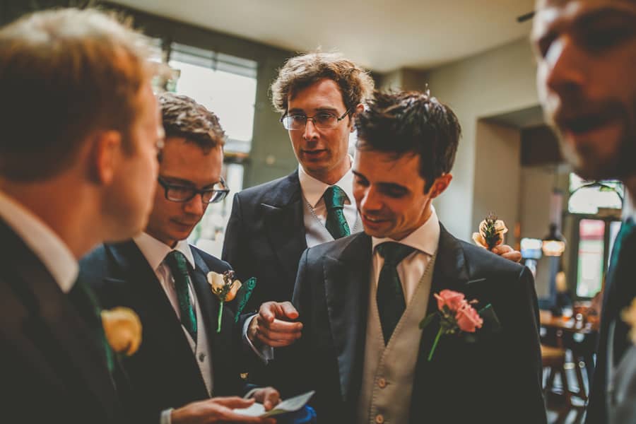 The groom looks at a list written by the best man