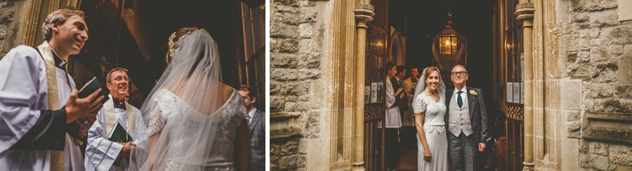 The bride is greeted by the vicar outside the Church at Fulham Palace gardens