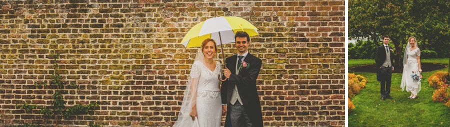 The bride and groom pose for a photograph in the walled gardens at Fulham Palace
