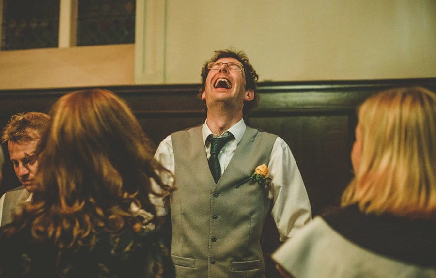 An usher closes his eyes and laughs on the dancefloor at Fulham Palace