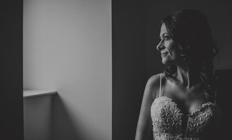 The bride looks out of her flat window