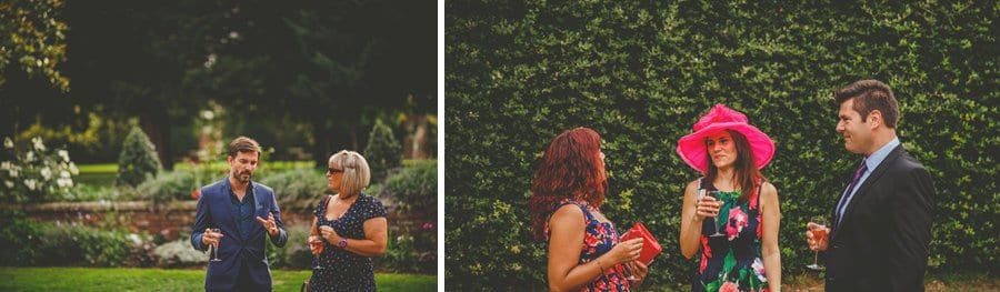 Wedding guests chat in the gardens at Goldney Hall wedding venue in Clifton