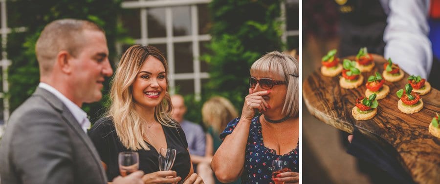 Wedding guests drink champagne and eat canapes