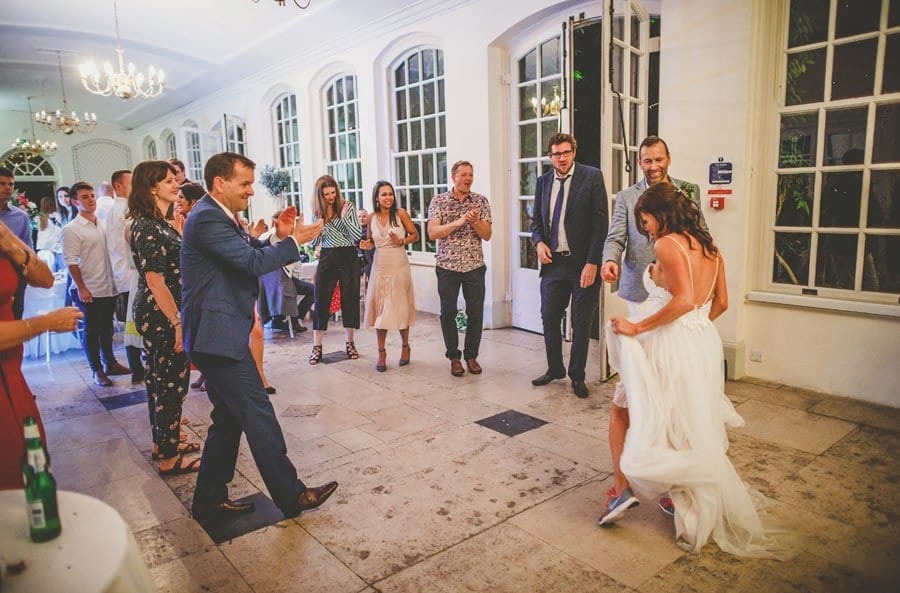 The wedding guests congratulate the bride and groom on the dancefloor