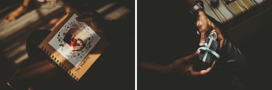 The bride looks at her photo book in her bedroom next to a window