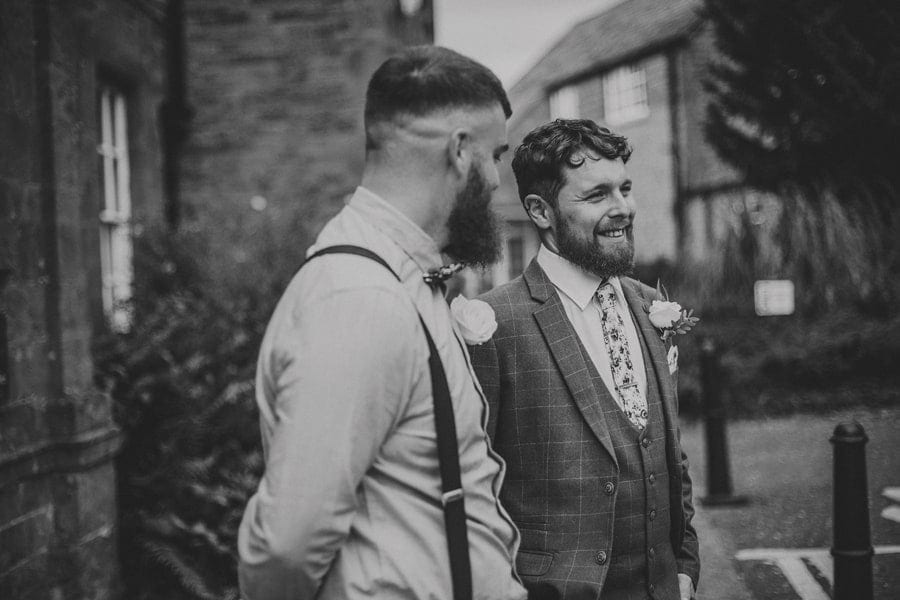 The groom and his best man share a joke together