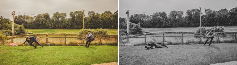 Wedding guests playing tug of war in the garden at Hadsham Farm