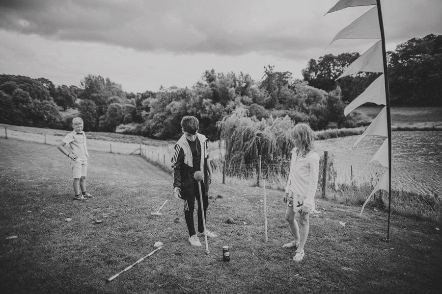 Children play with coconuts in the field at Hadsham Farm
